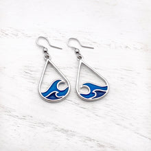 Load image into Gallery viewer, Curling Wave Earrings displayed on a white wooden surface.