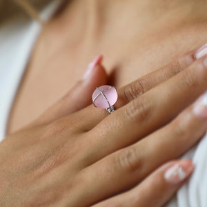 Hand-Wired Pink Sea Glass Ring displayed closely by being worn on a woman's finger.