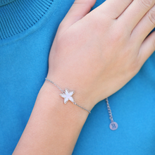 Load image into Gallery viewer, Mother of Pearl Single Starfish Bracelet displayed by being worn on a woman's arm.