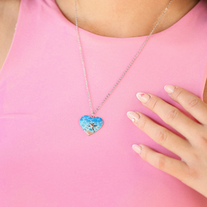 My Heart Belongs to the Sea Resin Necklace is displayed as it is worn around a woman's neck.