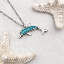 Load image into Gallery viewer, Ocean Treasure Sand Dolphin Necklace displayed on a white wooden surface.