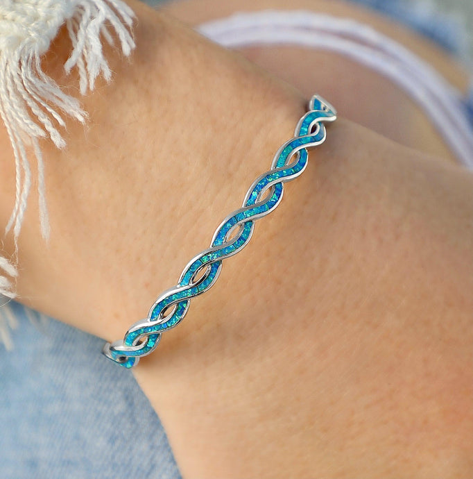 Opal Braided Cuff Bracelet displayed by being worn around a woman's wrist.