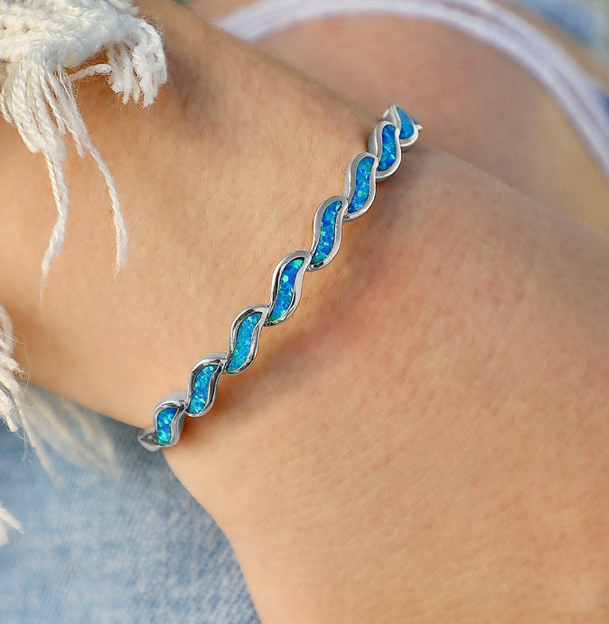 Opal Delicate Waves Cuff Bracelet displayed by being worn around a woman's wrist.