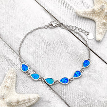 Load image into Gallery viewer, Opal Droplet Bracelet displayed on a white wooden surface.