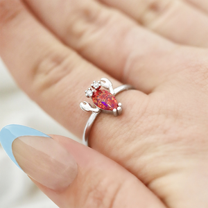 Opal Lobster Ring being shot up close while being worn on a finger.