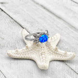 Opal Nautical Crab Ring is placed on top of a dried white artificial starfish.