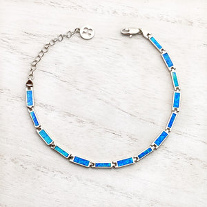 Opal Paradise Chain Bracelet displayed on a white wooden surface.