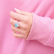 Load image into Gallery viewer, Sand Heart Ring displayed up close by being worn on a woman&#39;s hand.