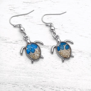 Sand Sea Turtle Earrings displayed on a white wooden surface.