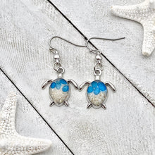 Load image into Gallery viewer, Sand Sea Turtle Earrings displayed on a white wooden surface.