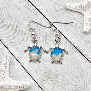 Sand Sea Turtle Earrings displayed on a white wooden surface.