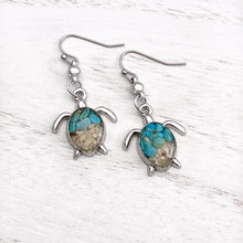 Load image into Gallery viewer, Sand Sea Turtle Earrings displayed on a white wooden surface.