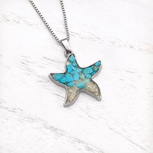 Load image into Gallery viewer, Sand Starfish Necklace in Teal Turquoise displayed on a white wooden surface.