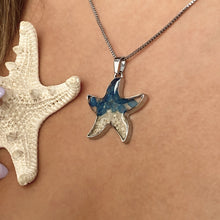 Load image into Gallery viewer, Sand Starfish Necklace in Blue Glass displayed closely by being worn around a woman's neck.
