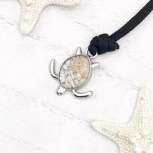 Load image into Gallery viewer, Black Rope Sand Sea Turtle Bracelet in White Turquoise is displayed in a white wooden surface.