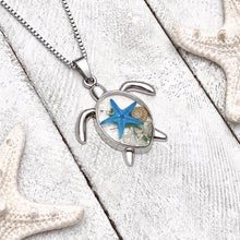 Load image into Gallery viewer, Deep in the Ocean Sea Turtle Necklace displayed on a white wooden surface.