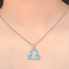 Load image into Gallery viewer, Opal Libra Necklace displayed closely by being worn around a woman&#39;s neck.