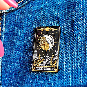 The Moon Tarot Card Pin displayed on denim cloth.