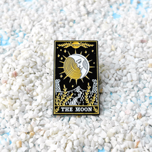 Load image into Gallery viewer, The Moon Tarot Card Pin displayed on sandy terrain.