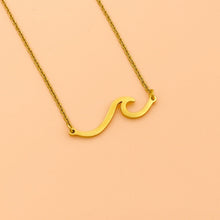 Load image into Gallery viewer, Wave Necklace displayed against a smooth peach background.