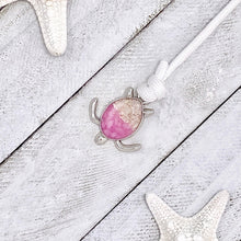 Load image into Gallery viewer, White Rope Sand Sea Turtle Bracelet in Pink Pebble is displayed on a white wooden surface.