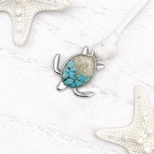 White Rope Sand Sea Turtle Bracelet in Teal Turquoise is displayed on a white wooden surface.