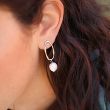 Load image into Gallery viewer, .925 Silver Pearl Irregular Oval Earrings displayed by being worn on a woman&#39;s ear.