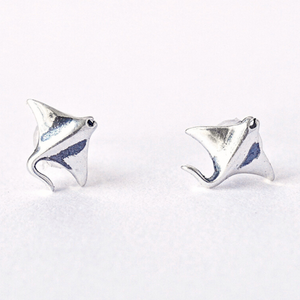 .925 Vintage Sterling Silver Manta Ray Studs are displayed in a rough white surface.
