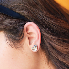 Load image into Gallery viewer, Abalone Sand Heart Studs is displayed up close by being worn on a woman&#39;s ear.