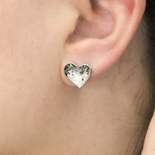 Load image into Gallery viewer, Abalone Sand Heart Stud displayed by being worn on a woman&#39;s ear.