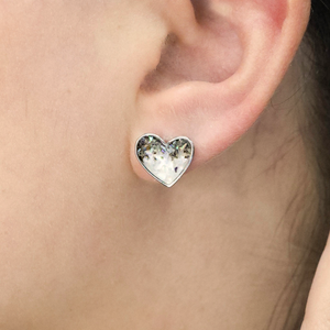 Abalone Sand Heart Stud displayed by being worn on a woman's ear.
