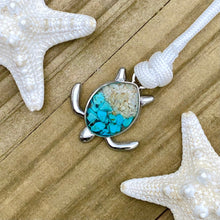 Load image into Gallery viewer, White Rope Teal Sand Turtle Bracelet displayed on a wooden surface.