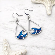 Load image into Gallery viewer, Curling Wave Earrings displayed on a white wooden surface.