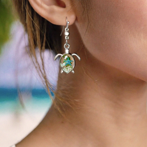 Deep in the Ocean Sea Turtle Earring displayed by being worn on a woman's ear.