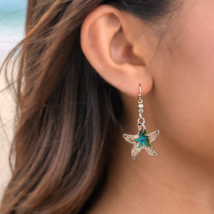 Deep in the Ocean Starfish Earrings displayed up close by being worn on a woman's ear.