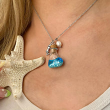 Load image into Gallery viewer, Drift Bottle Mermaid Necklace displayed by being worn around a woman&#39;s neck.