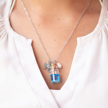 Load image into Gallery viewer, Drift Bottle Sea Turtle Necklace worn around a woman&#39;s neck.