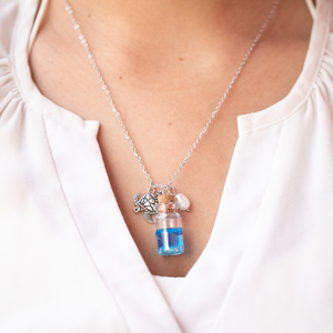 Drift Bottle Sea Turtle Necklace worn around a woman's neck.