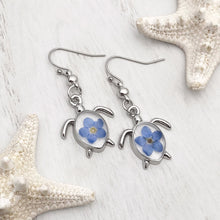 Load image into Gallery viewer, Forget Me Not Sea Turtle Earrings displayed on a white wooden surface, ideal spring jewelry.