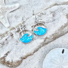 Load image into Gallery viewer, Glittering Wave Earrings are displayed by being placed on top of a sand covered driftwood.