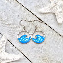 Load image into Gallery viewer, Glittering Wave Earrings displayed on a white wooden surface.