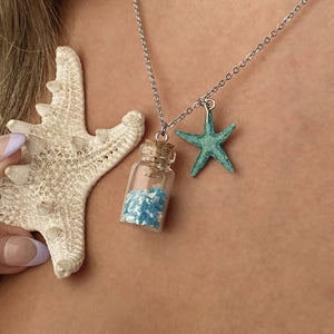 Glowing Sand Jar Necklace displayed by being worn around a woman's neck.