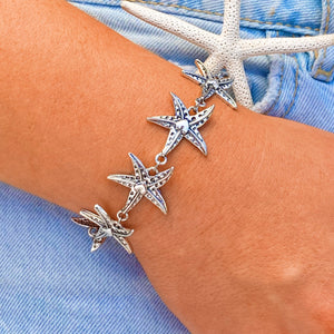 Happy Starfish Heart Bracelet displayed by being worn around a woman's wrist