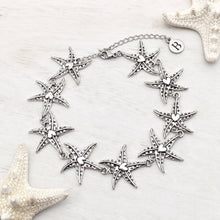 Load image into Gallery viewer, Happy Starfish Heart Bracelet displayed on a white wooden surface.