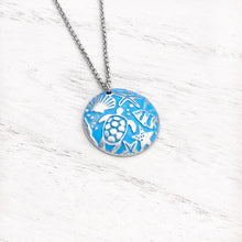 Load image into Gallery viewer, Into the Blue Necklace displayed on a white wooden surface.