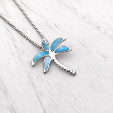 Load image into Gallery viewer, Larimar Palm Tree Necklace displayed on a white wooden surface.