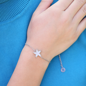 Mother of Pearl Single Starfish Bracelet displayed by being worn on a woman's arm.