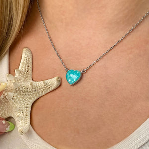 Ocean Treasure Sand Heart Necklace worn around a woman's neck.