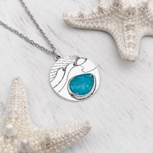 Load image into Gallery viewer, Ocean Treasure Sand Wave Necklace is positioned on top of a white wooden surface.