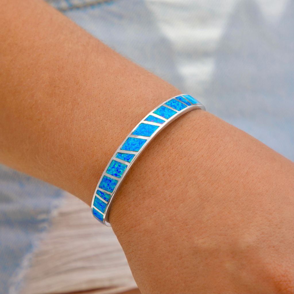 Opal Cuff Bracelet displayed by being worn around a woman's wrist.